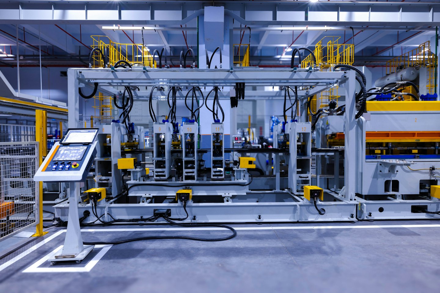 Automatisierte Roboterarme, die an einer Maschine in einer Fabrik arbeiten.